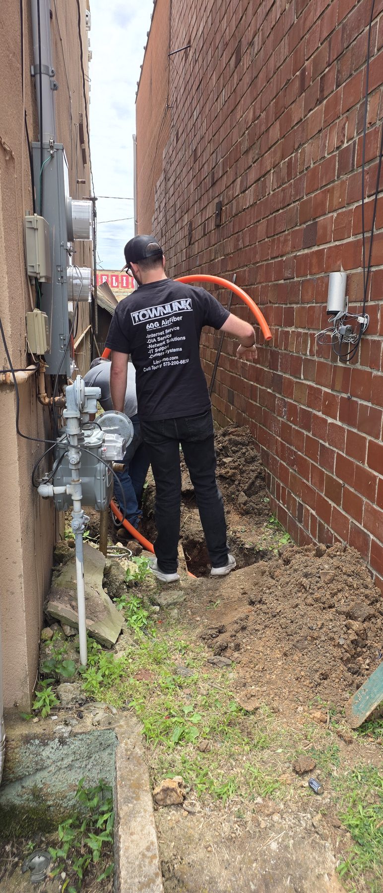 TownLink crew installing conduit for a downtown business
